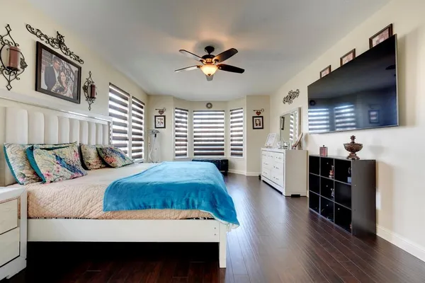 a bedroom with a bed and a flat screen tv