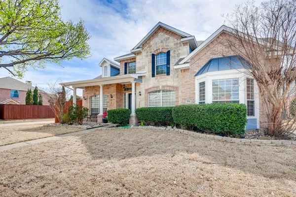 a front view of a house with a yard and a garage