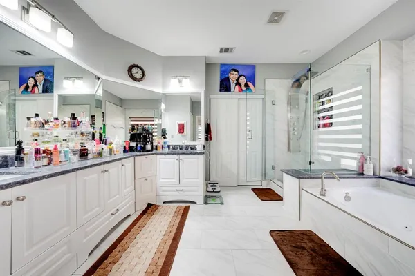 a large white kitchen with lots of counter top space