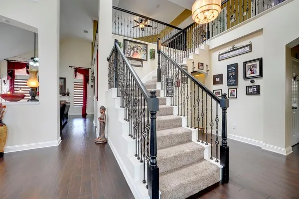 a view of entryway and hall with wooden floor