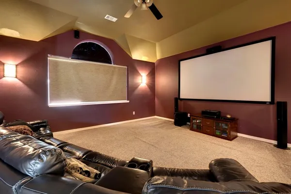 a room with gym equipment and a flat screen tv