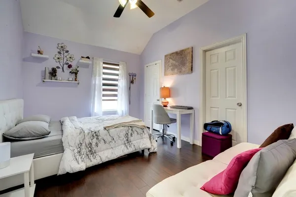 a bedroom with furniture and a window