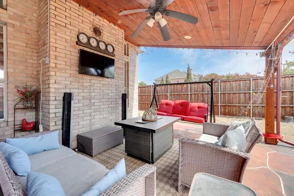 a living room with furniture a flat screen tv and a fireplace