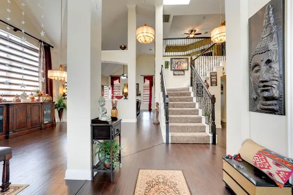 a view of entryway and hall with wooden floor