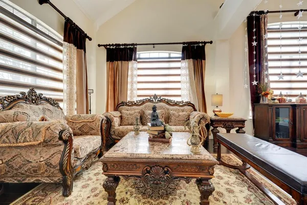 a living room with furniture and large windows