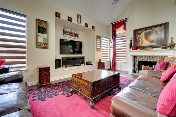 a living room with furniture flat screen tv and a fireplace
