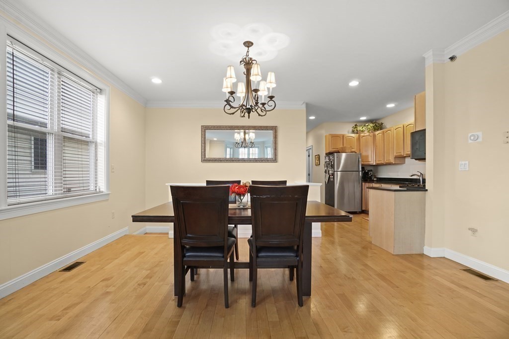 8 Howell Street, Unit 1 Boston, MA 02125 - Photo 3 of 14 a view of a dining room with furniture window and wooden floor