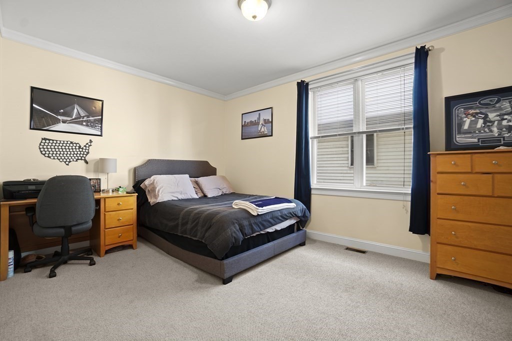 8 Howell Street, Unit 1 Boston, MA 02125 - Photo 6 of 14 a bedroom with a bed and chair