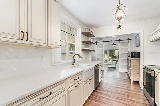a kitchen with cabinets and wooden floor