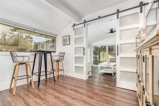 a view of a dining room with furniture and wooden floor
