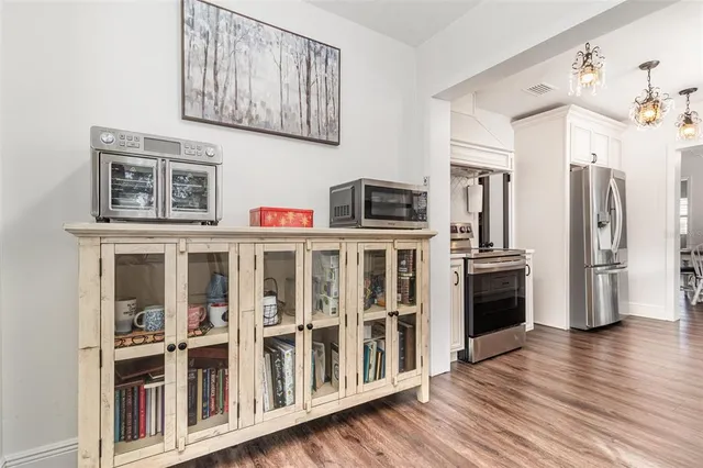 a kitchen with stainless steel appliances granite countertop a refrigerator and a stove top oven