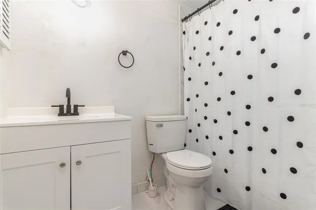 a bathroom with a toilet a sink and a mirror