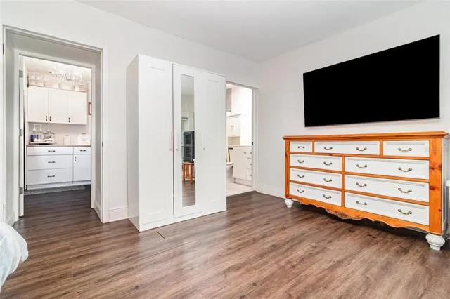 a view of living room with flat screen tv and wooden floor
