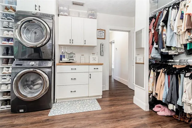 a view of a storage and utility room with wooden floor
