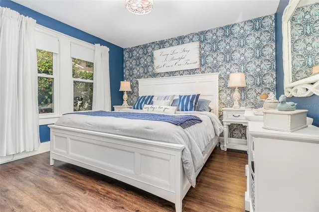 a bed sitting in a bedroom next to a window