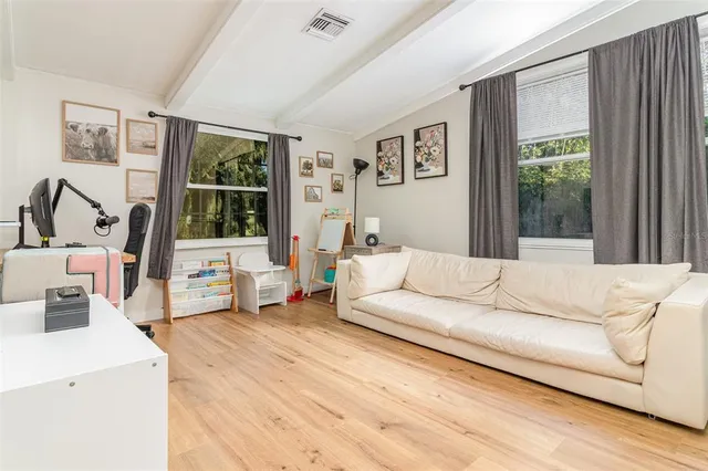 a bedroom with a bed a chandelier and closet