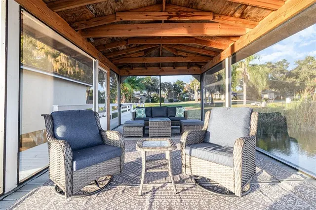 a view of a swimming pool with a patio and plants