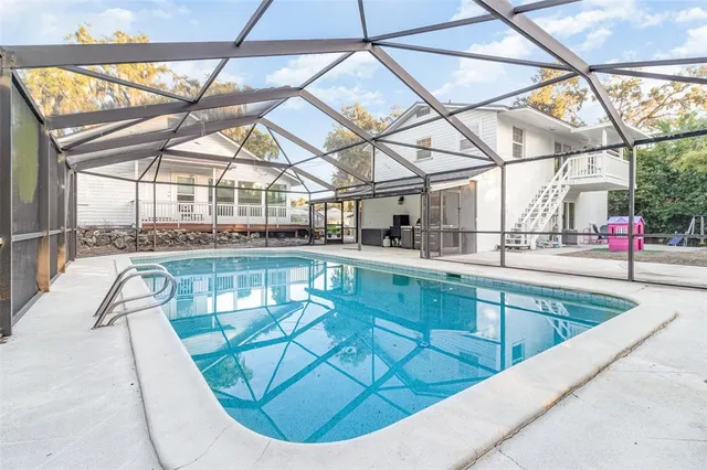 a front view of a house with a yard and potted plants