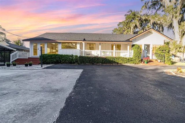 a view of a house with patio and a yard