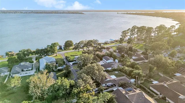 a view of a lake with lawn chairs