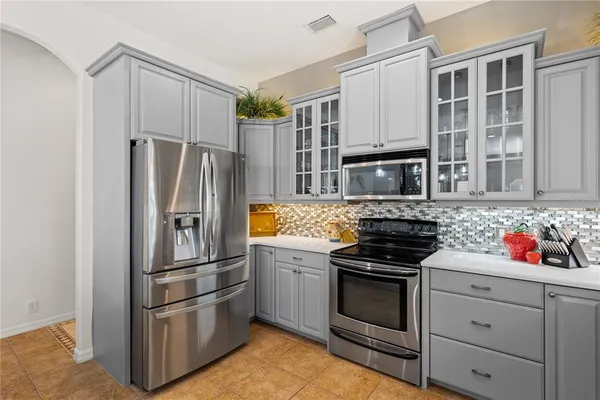 a kitchen with granite countertop stainless steel appliances and counter space