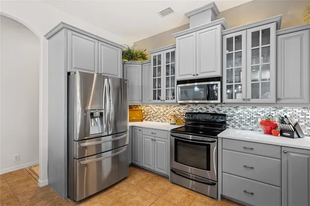 a kitchen with granite countertop stainless steel appliances and counter space