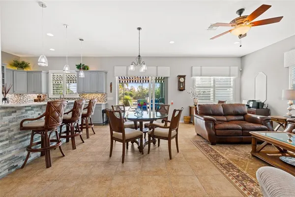 a living room with lots of furniture and a chandelier