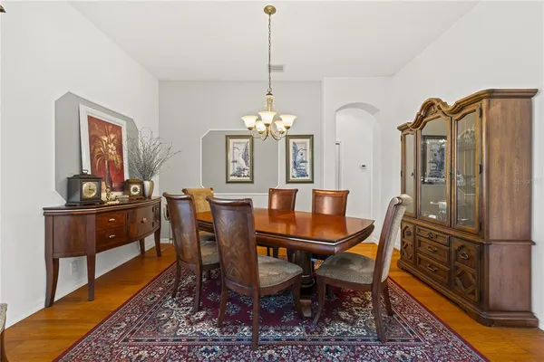 a dining room with furniture a rug and a chandelier