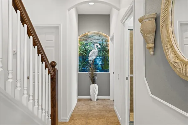 a view of a hallway with wooden floor and stairs