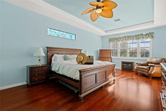 a bedroom with a bed and wooden floor