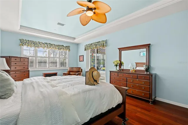 a bedroom with a bed and large windows