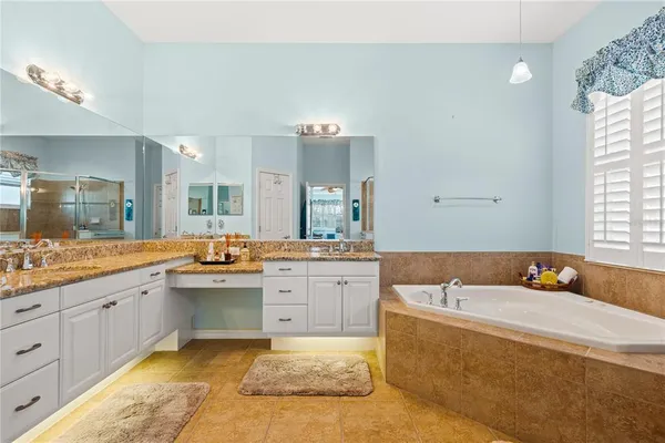 a large bathroom with a large tub sink and vanity