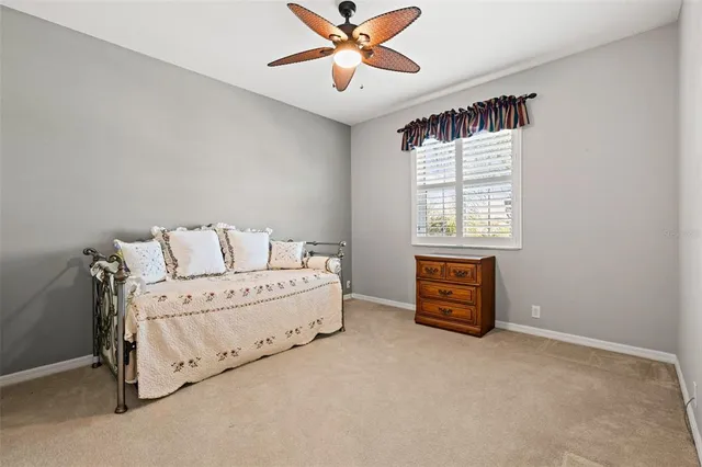 a spacious bedroom with a bed and a chandelier