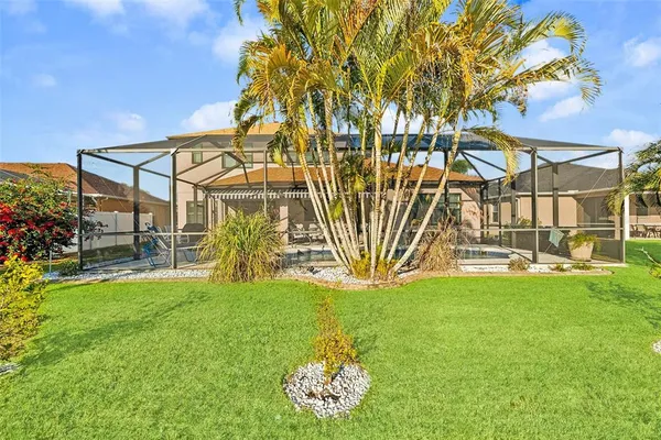 a backyard of a house with lots of green space and fountain