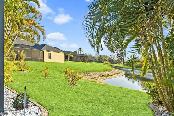 a view of an house with backyard space and lakeside