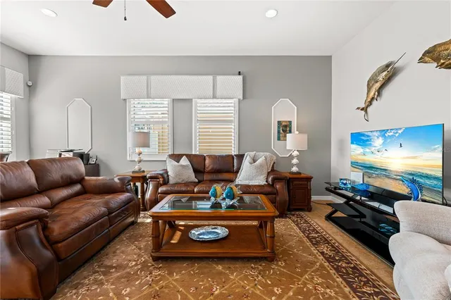 a living room with furniture wooden floor and a window