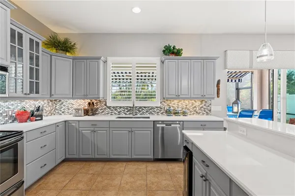 a kitchen with a sink stove and cabinets