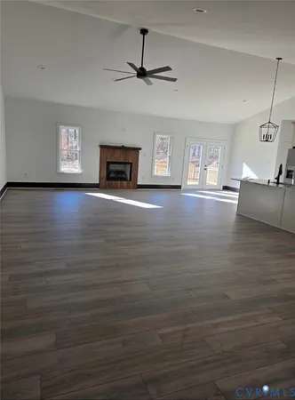 a view of a livingroom with hardwood floor and a ceiling fan