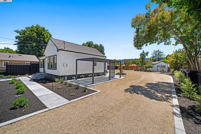 a view of a backyard with wooden fence