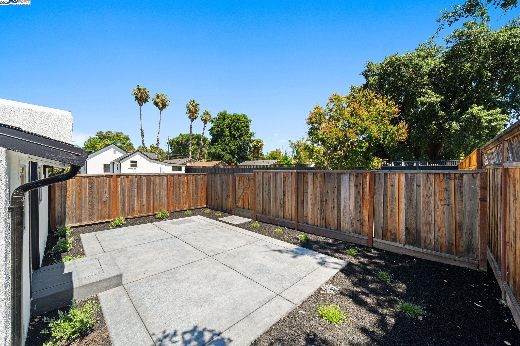1038 Division Street Pleasanton, CA 94566 - Photo 14 of 53 a view of a backyard with wooden fence