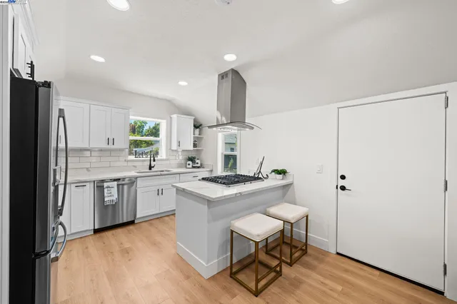 a living room with furniture a rug and a floor to ceiling window