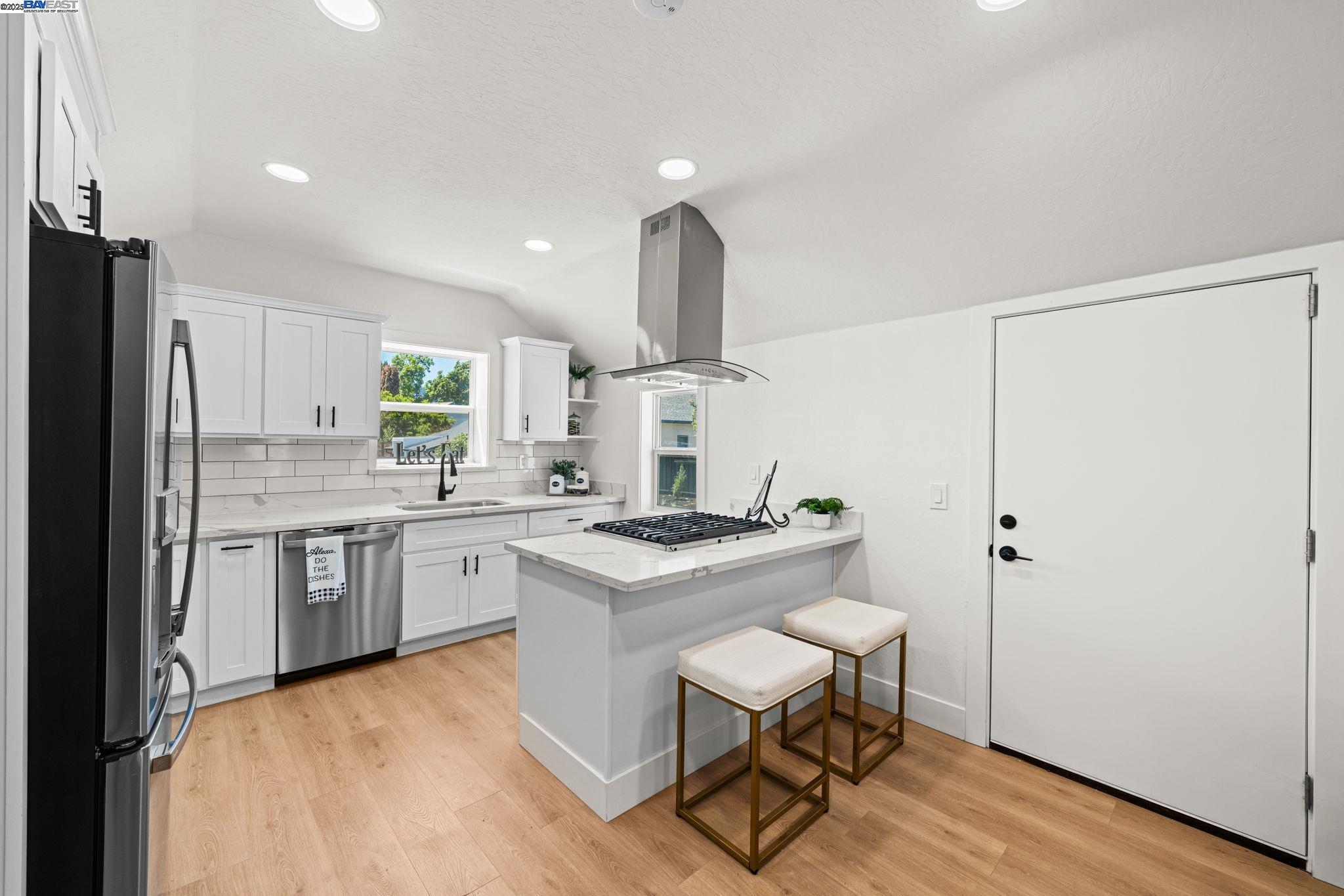 1038 Division Street Pleasanton, CA 94566 - Photo 28 of 53 a kitchen with a stove a sink and a refrigerator