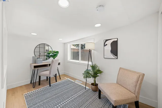 a living room with furniture potted plant and a window