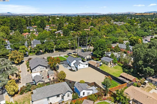 an aerial view of residential houses with outdoor space