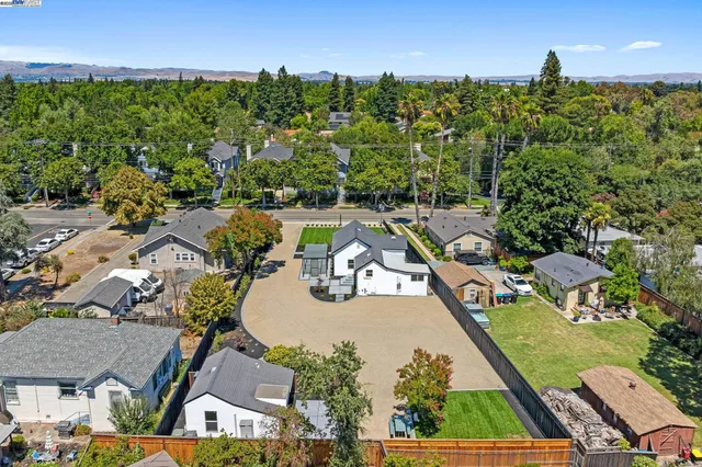 an aerial view of a house with garden space and outdoor seating