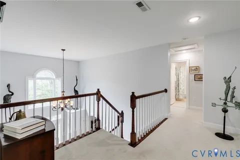 a view of a hallway with a staircase