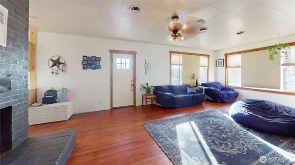 a living room with furniture wooden floor and window