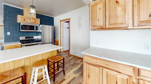 a kitchen with stainless steel appliances a stove and a refrigerator