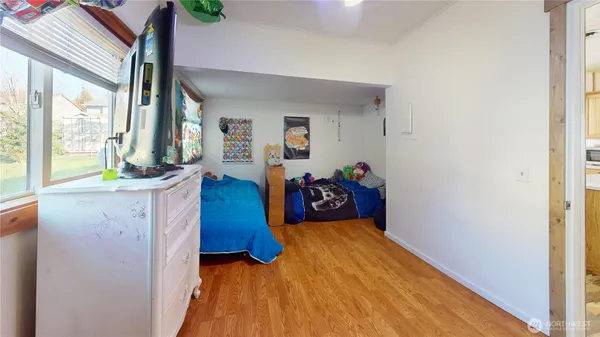 a bed room with a bed and a large window