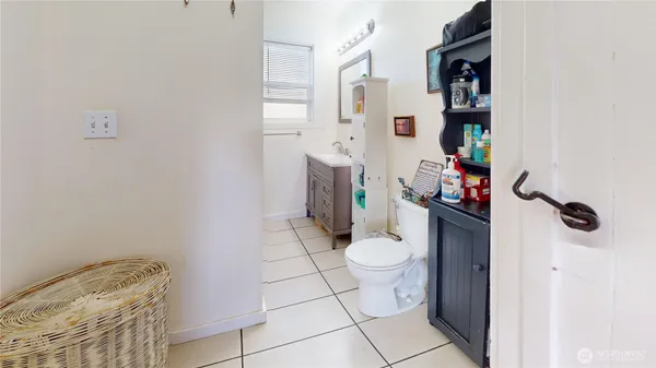 a bathroom with a toilet and a shower curtain